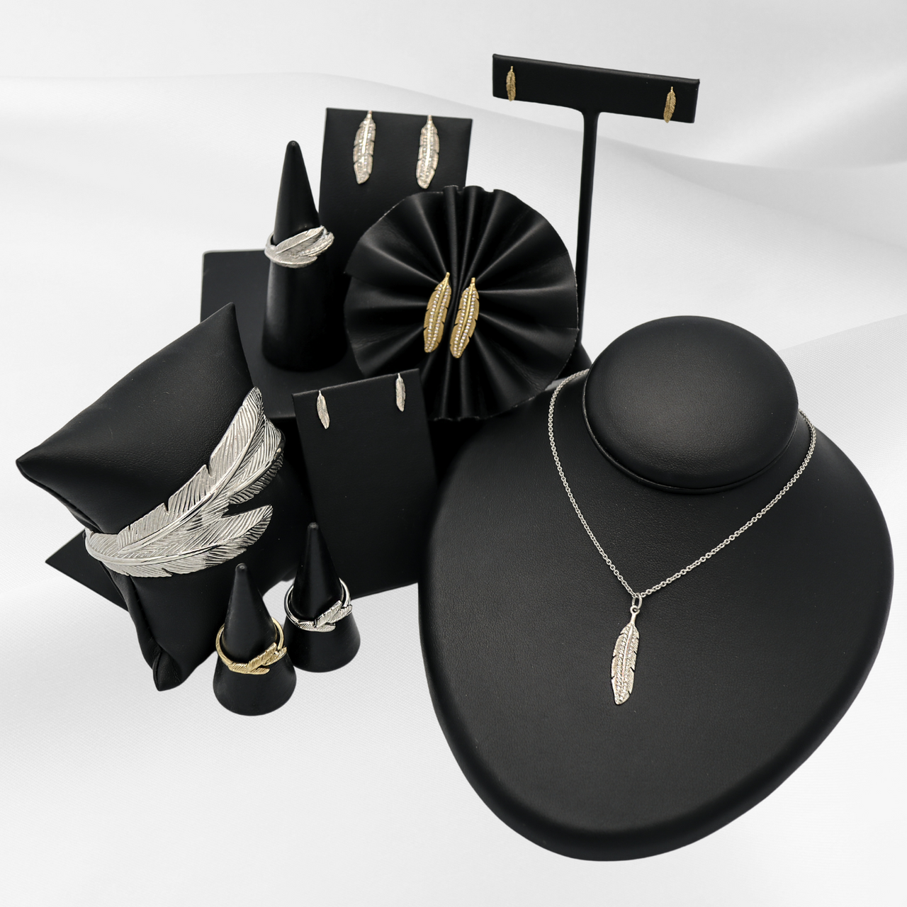 Soar with Joy™ collection of ladies jewelry including earrings, rings, necklace, and cuff bracelet in sterling silver and 14k yellow gold.
