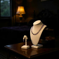 Thumbnail for Necklace on a white bust and earring stand on a wooden table with a blurred background